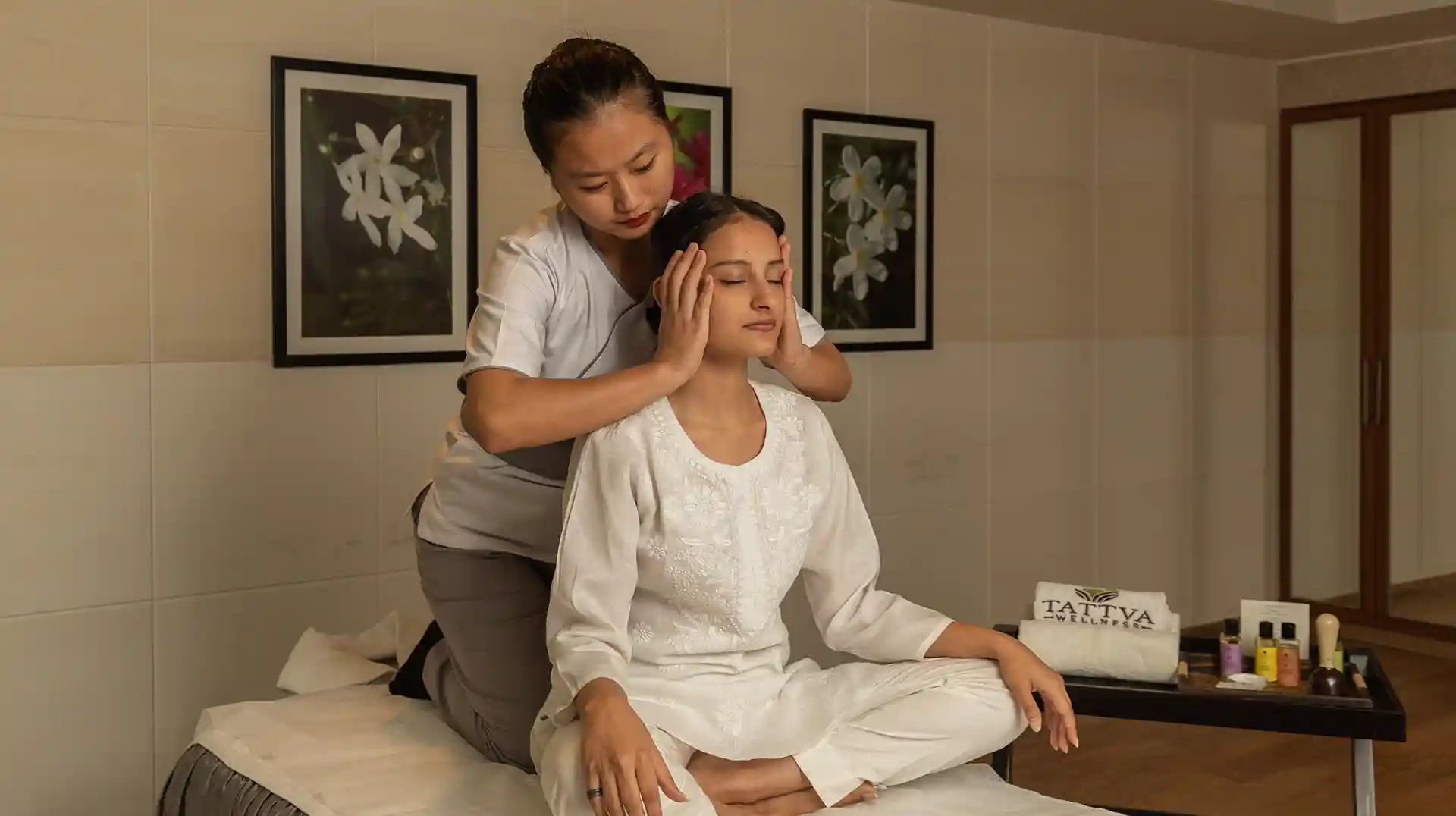 Spa therapist at Tattva Wellness Spa performing a traditional head and neck massage, enhancing relaxation and holistic well-being.