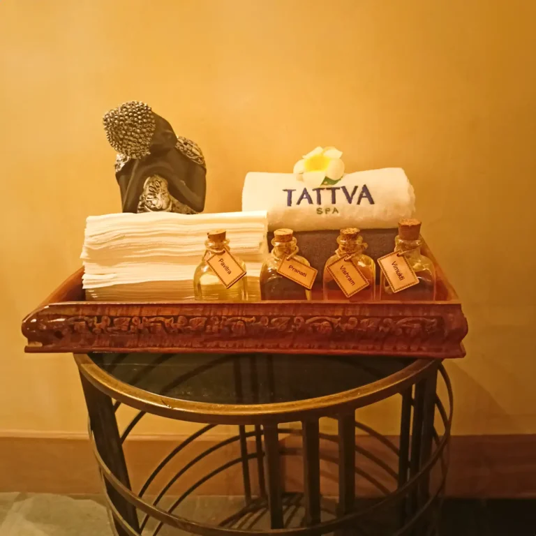 Selection of essential oils and Tattva Spa towel displayed on a decorative tray at Radisson Udyog Vihar Gurgaon.