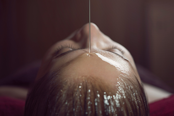oil dripping on a girls head