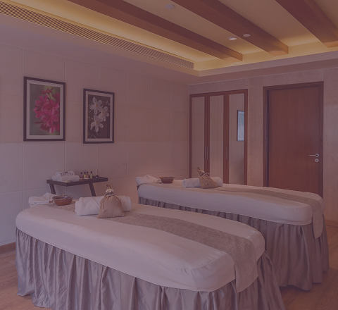 Elegant couple spa room at Tattva Wellness Spa with two massage beds, soothing interiors, and a serene ambiance for shared relaxation.