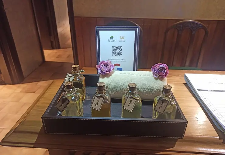 A premium spa essentials including Tattva herbal massage oils, neatly arranged towels, and aromatic décor items used to enhance relaxation and rejuvenation during a couple spa therapy
