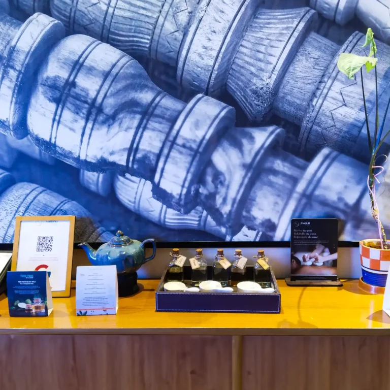 Aromatherapy oils and wellness display at Too Yoo Spa & Salon with tea pot, essential oils, and décor accents.