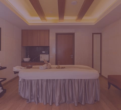 Well-appointed single spa room at Tattva Wellness Spa with a massage bed and calming interiors for a private relaxation experience.