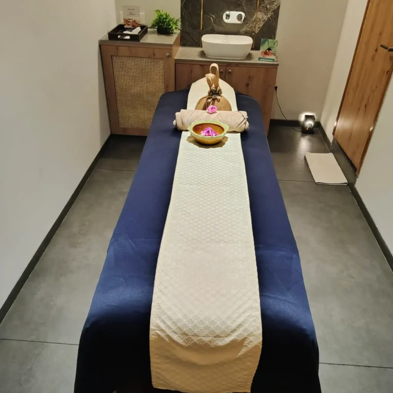 Massage therapy room at Too Yoo by Tattva Wellness Spa – Richmond Road, Langford Gardens, Bengaluru, featuring a neatly arranged spa bed with fresh towels and wellness essentials.