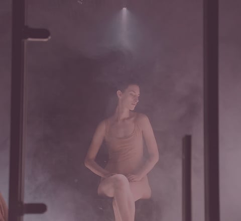 Guest relaxing inside a steam room at Tattva Wellness Spa, surrounded by soothing mist for detoxification and deep relaxation.