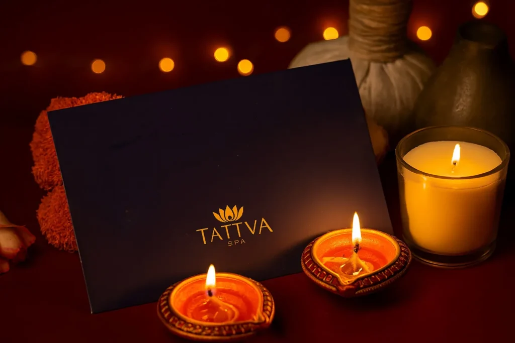 Tattva Spa Diwali gift card surrounded by candles and diyas, symbolizing wellness gifting this festive season.