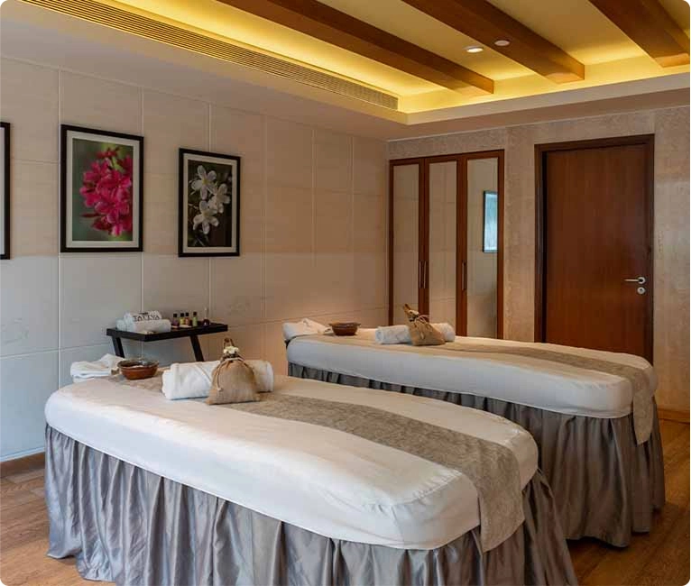 Tattva Spa couple spa room featuring two spa beds placed side by side, designed for a relaxing and rejuvenating couple massage experience.