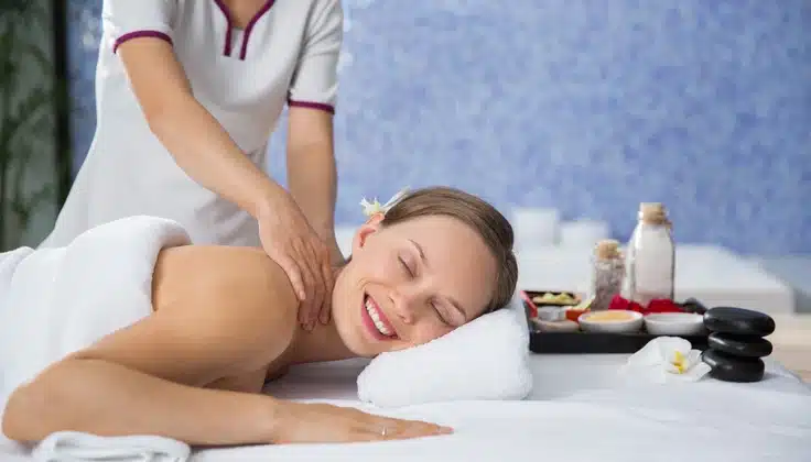 Woman receiving a relaxing Full Body Massage from a therapist at a spa.
