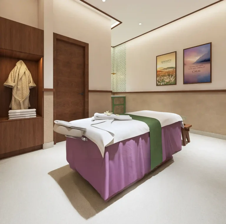 Modern spa therapy room at Tattva Wellness Spa, M3M 65th Avenue Gurgaon, featuring a massage bed with fresh linens and calming décor.