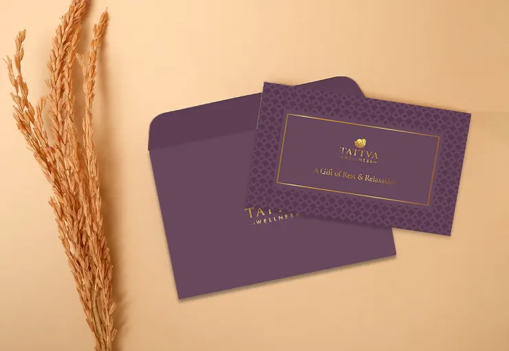 Tattva Wellness Spa gift card and elegant envelope placed on a beige background—a luxurious and thoughtful Raksha Bandhan gift idea for siblings who deserve a wellness treat.