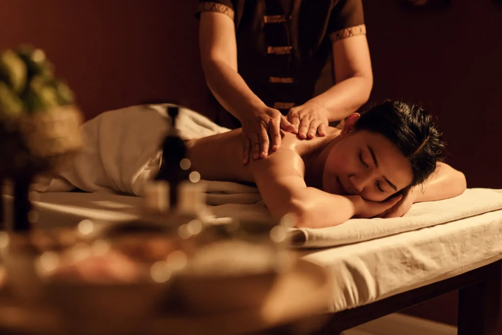 Woman lying on a spa bed during a back massage, experiencing the benefits of regular massage sessions for deep relaxation and improved wellbeing.