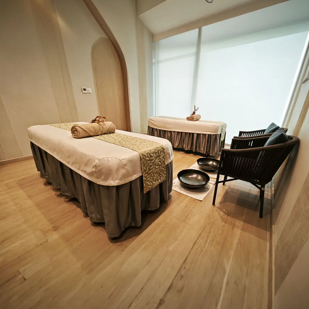a room with two spa beds and a chair