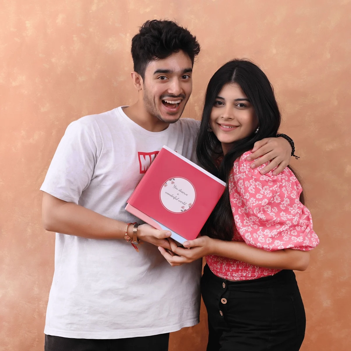 Brother surprising his sister with a Tattva Spa gift card as the perfect Rakhi Gift for Sisters, both sharing a joyful moment and embracing the festive Raksha Bandhan spirit.