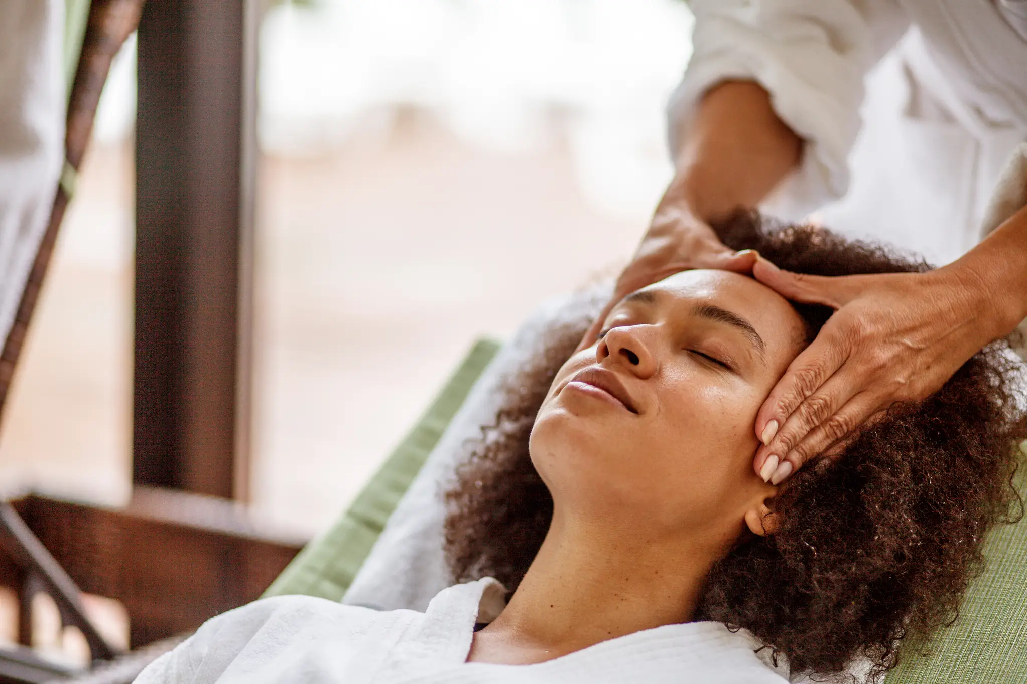a woman receiving a head massage massage to explore Mental Health Benefits