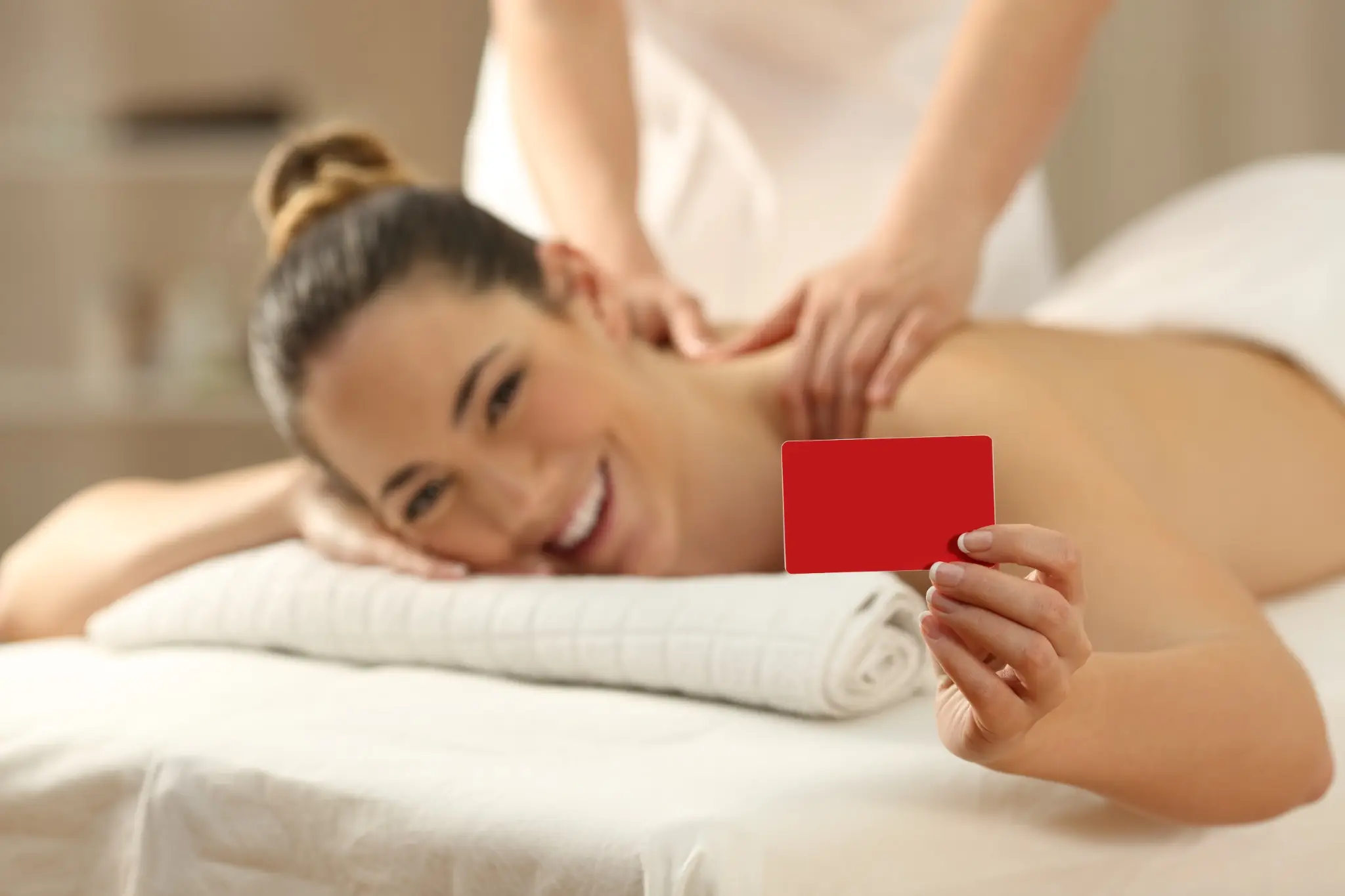 Woman enjoying a relaxing back massage at Tattva Wellness Spa while holding a gift card — a perfect birthday gift idea for wife.