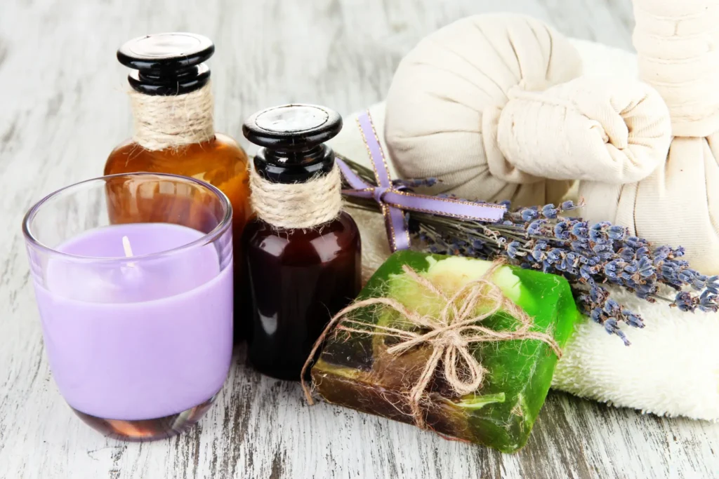Spa essentials including lavender candle, herbal soap, and massage oils arranged beautifully to symbolize the benefits of regular massage sessions and holistic wellness.
