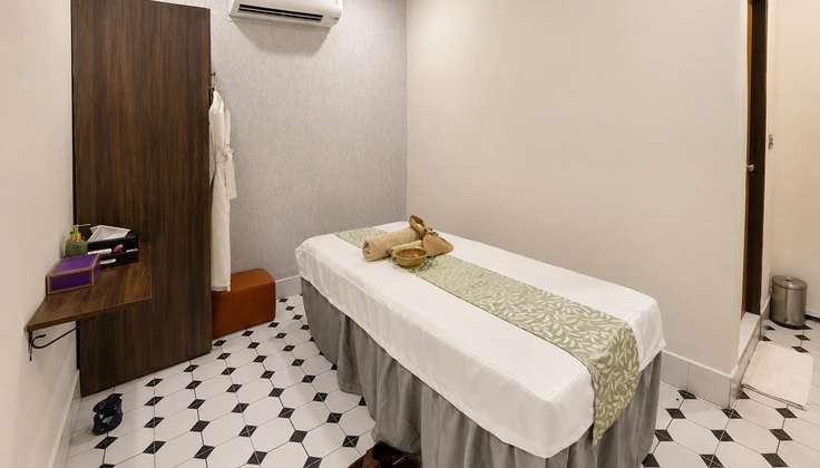 Private spa treatment room with a prepared massage bed for Tattva Tranquility Membership services.