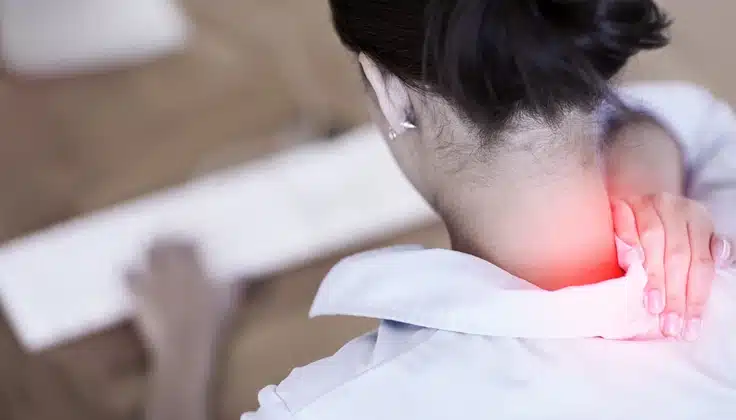 Person experiencing neck pain associated with cervical spondylosis.