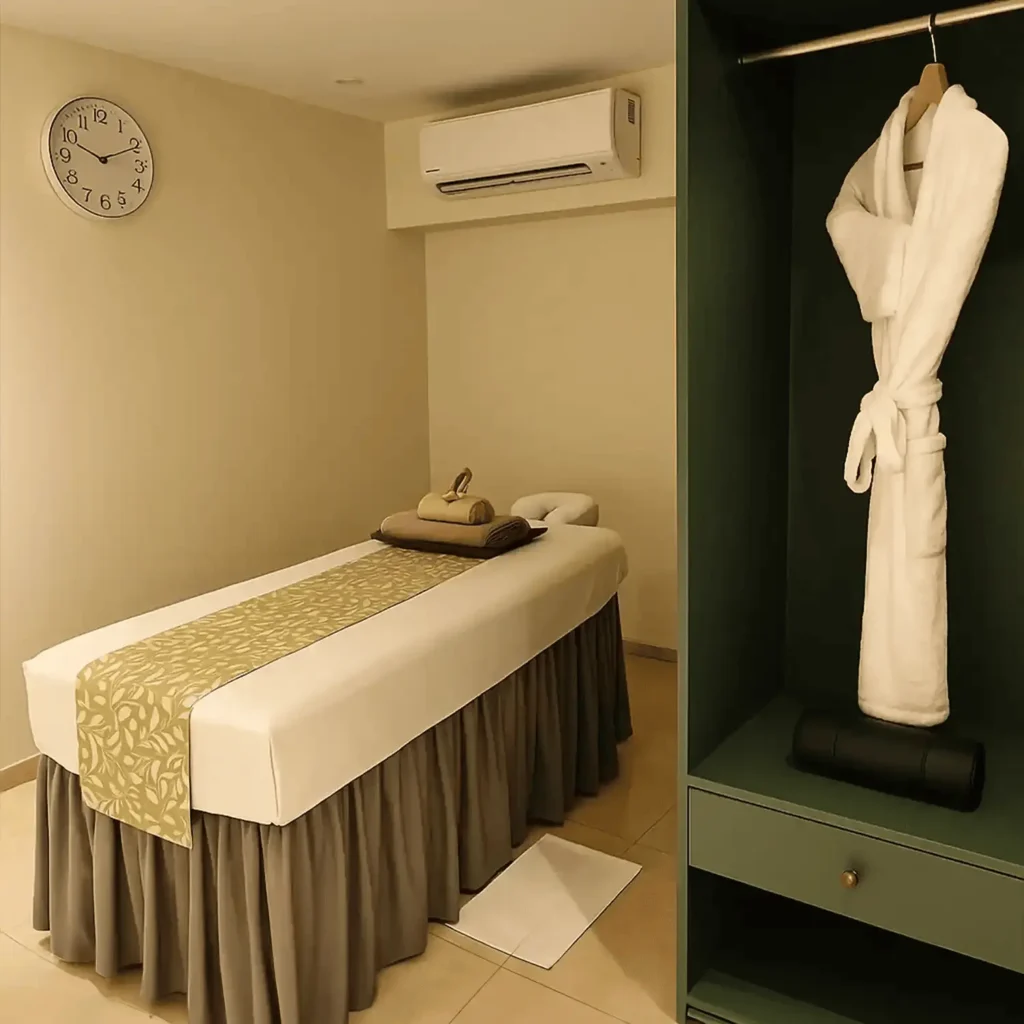 Swedish massage therapy room at Tattva Wellness Spa Hyderabad with massage bed, robe, and calming ambiance.