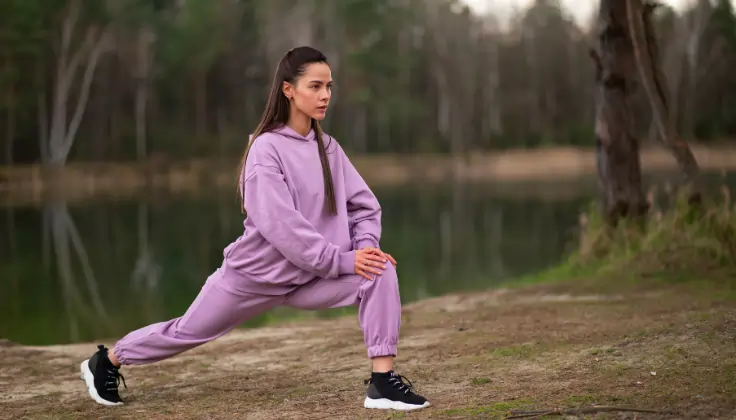 Woman doing light exercise in open air during winter to maintain energy and health