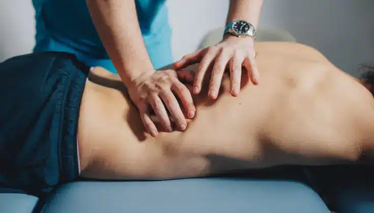 Man receiving massage therapy to support injury prevention and muscle recovery.