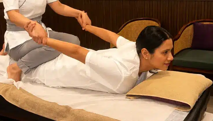 Guest receiving Tattva Signature Yoga Massage with assisted stretching techniques at Tattva Spa.