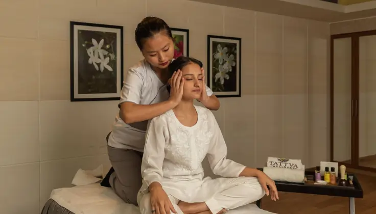 Guest receiving Tattva Signature Yoga Massage with guided head and neck relaxation techniques at Tattva Spa.