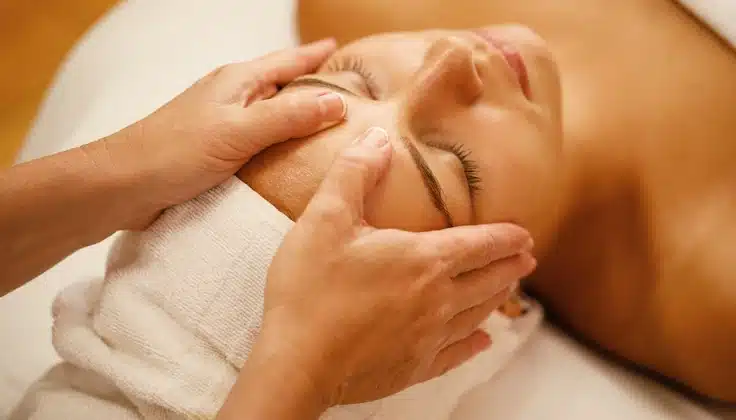 Guest receiving a facial massage to support relaxed, healthy-looking, and radiant skin.