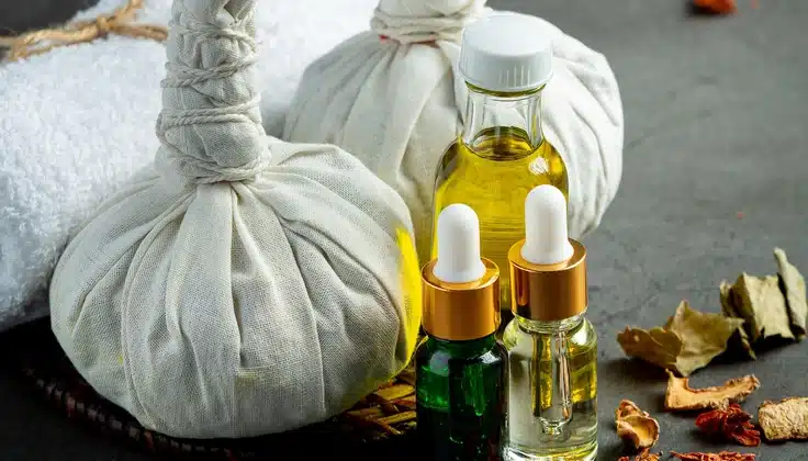 Herbal potli massage compresses with massage oils and dried herbs.
