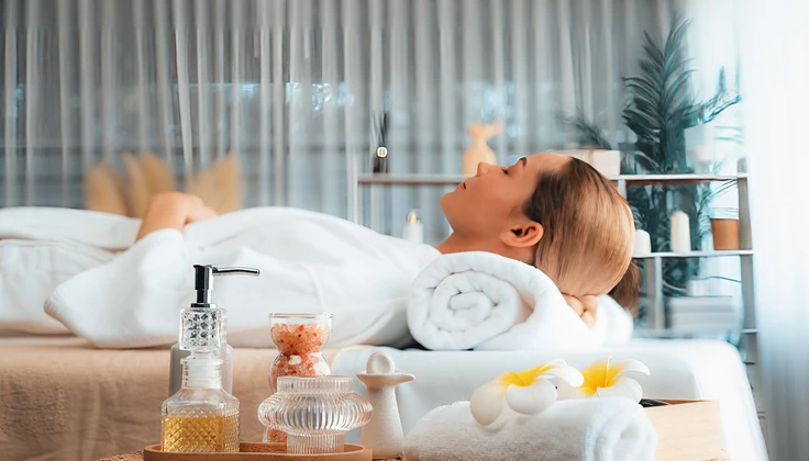 Woman relaxing on a massage table during a calming spa treatment.