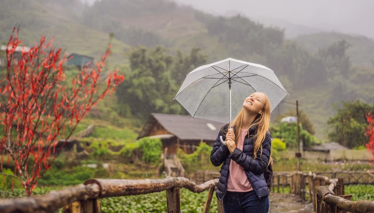Woman enjoying a peaceful rainy getaway in the hills, perfect when confused between a spa day and a vacation.