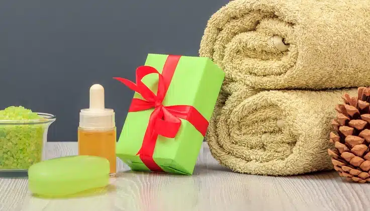 Raksha Bandhan 2026 Pre-Planning with a spa gift featuring rolled towels, massage oil, bath salts and a ribbon-wrapped present.