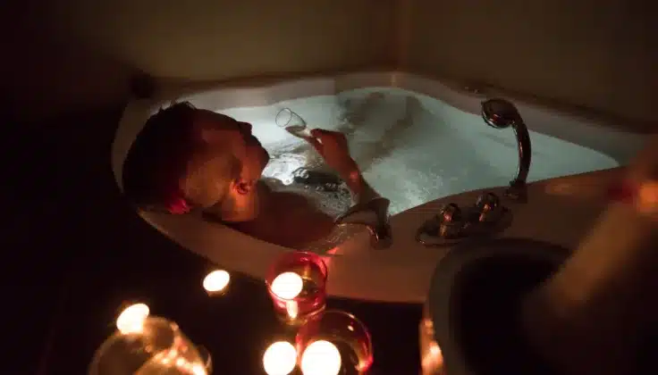 Guest enjoying a Jacuzzi spa experience in a calming ambience for relaxation and comfort.