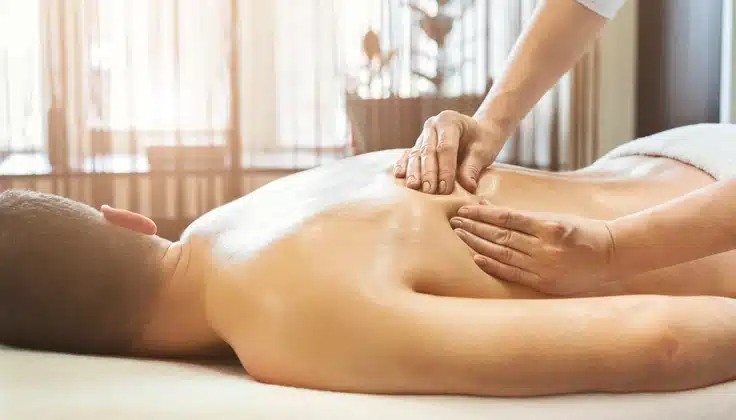 Guest receiving a relaxing back massage therapy to ease stress and muscle fatigue.