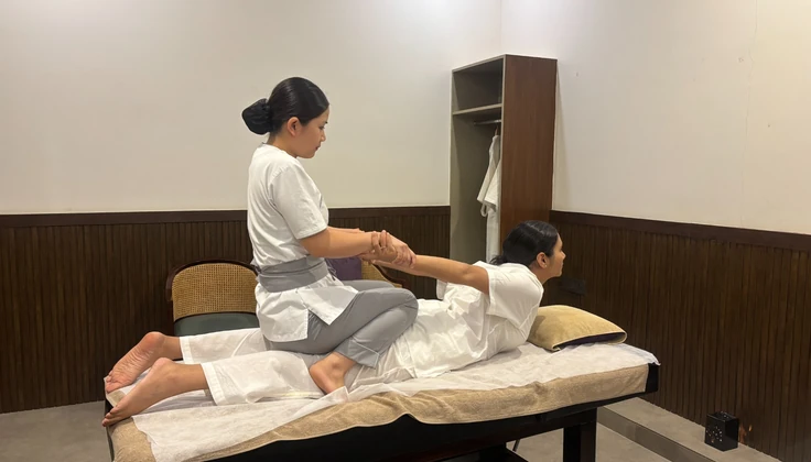 Guest experiencing a traditional Thai Yoga Massage with assisted stretching for improved flexibility.