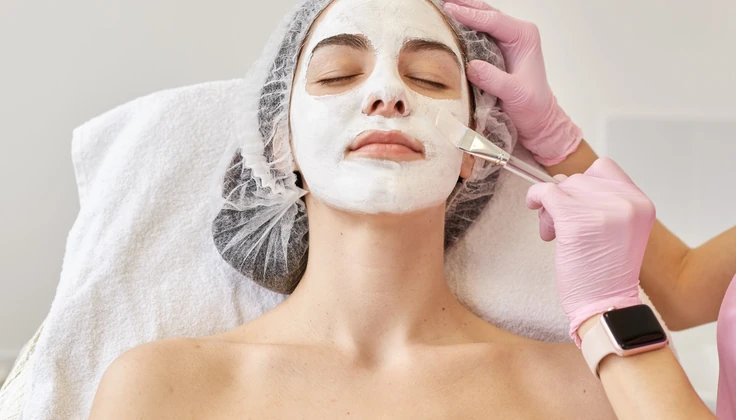Therapist applying a nourishing mask during a Rejuvenating Facial for refreshed and radiant skin.