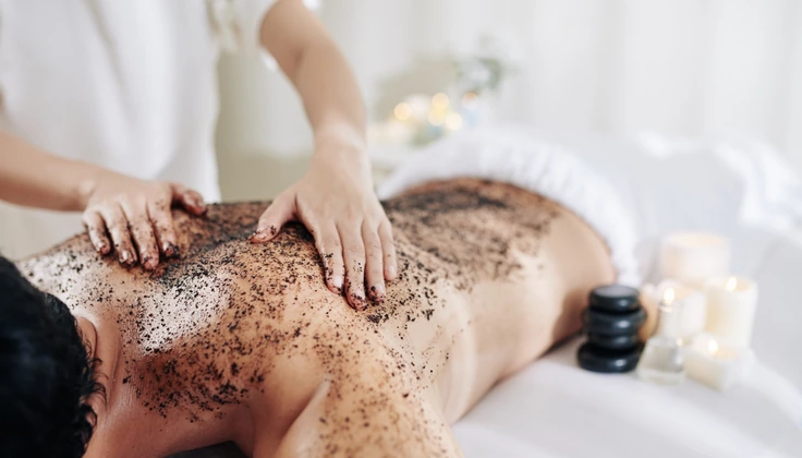 Radiance Body Scrub being applied during a full-body spa treatment.