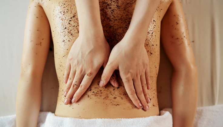 Radiance Body Scrub being gently applied to the back.