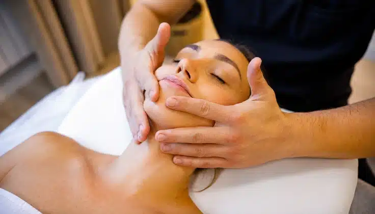 Guest receiving Lymphoglow Rejuvenation with targeted facial massage for relaxation and refreshed-looking skin.