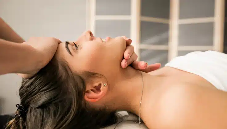 Guest receiving a relaxing head and neck massage at a spa.