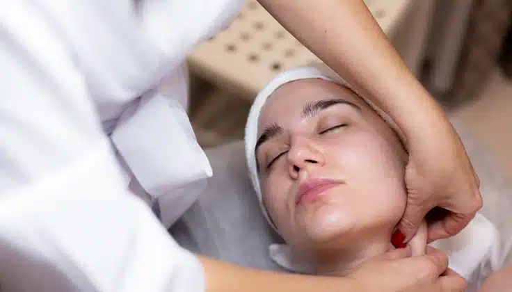 Guest receiving a Lymphatic Face Massage with gentle neck and facial techniques at Tattva Wellness Spa.