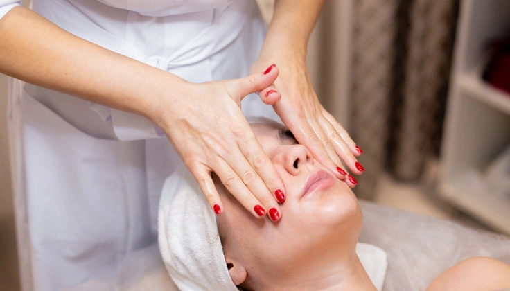 Alt Text: Woman receiving a facial massage for healthy and glowing skin.