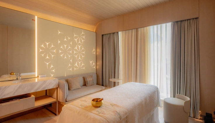 Modern spa treatment room prepared for a relaxing wellness session.
